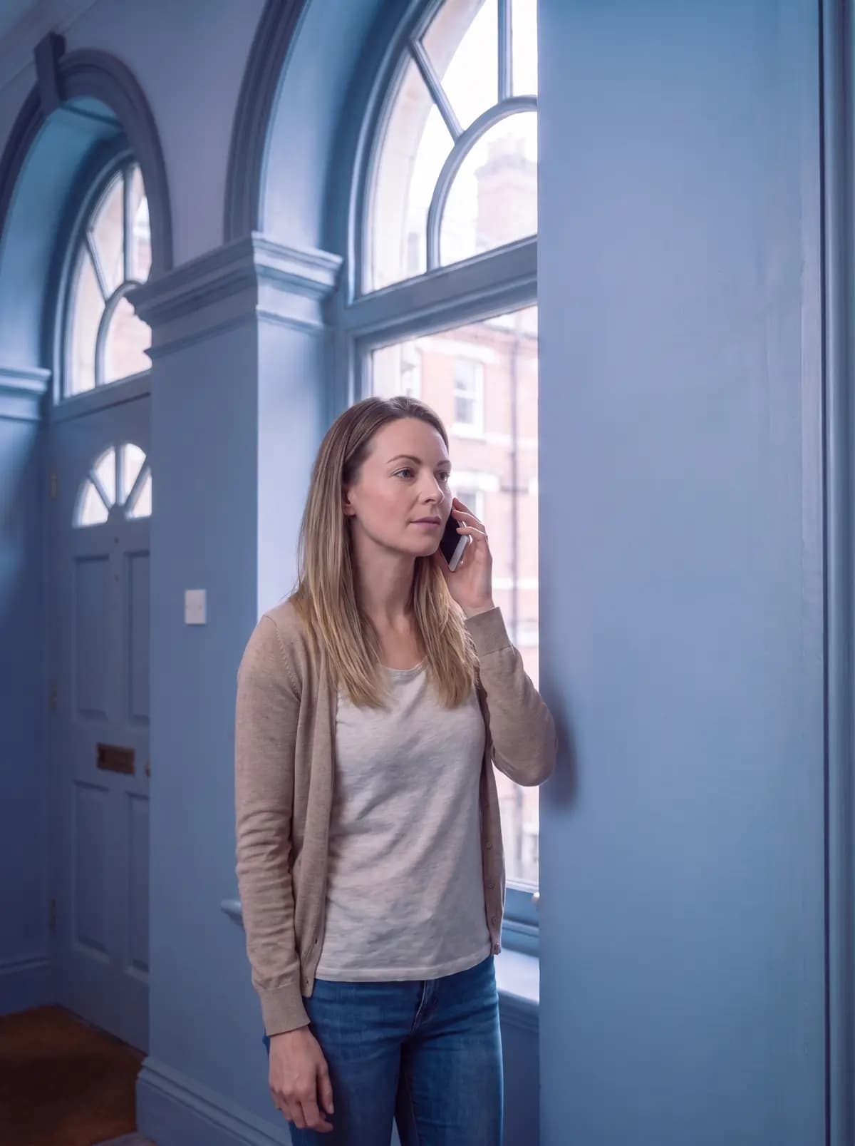 Homeowner on the phone in a hallway