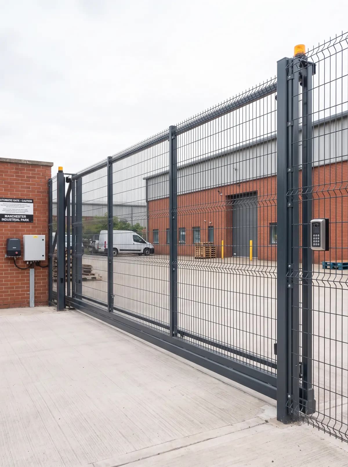 Mesh security gate across the entrance to an industrial yard