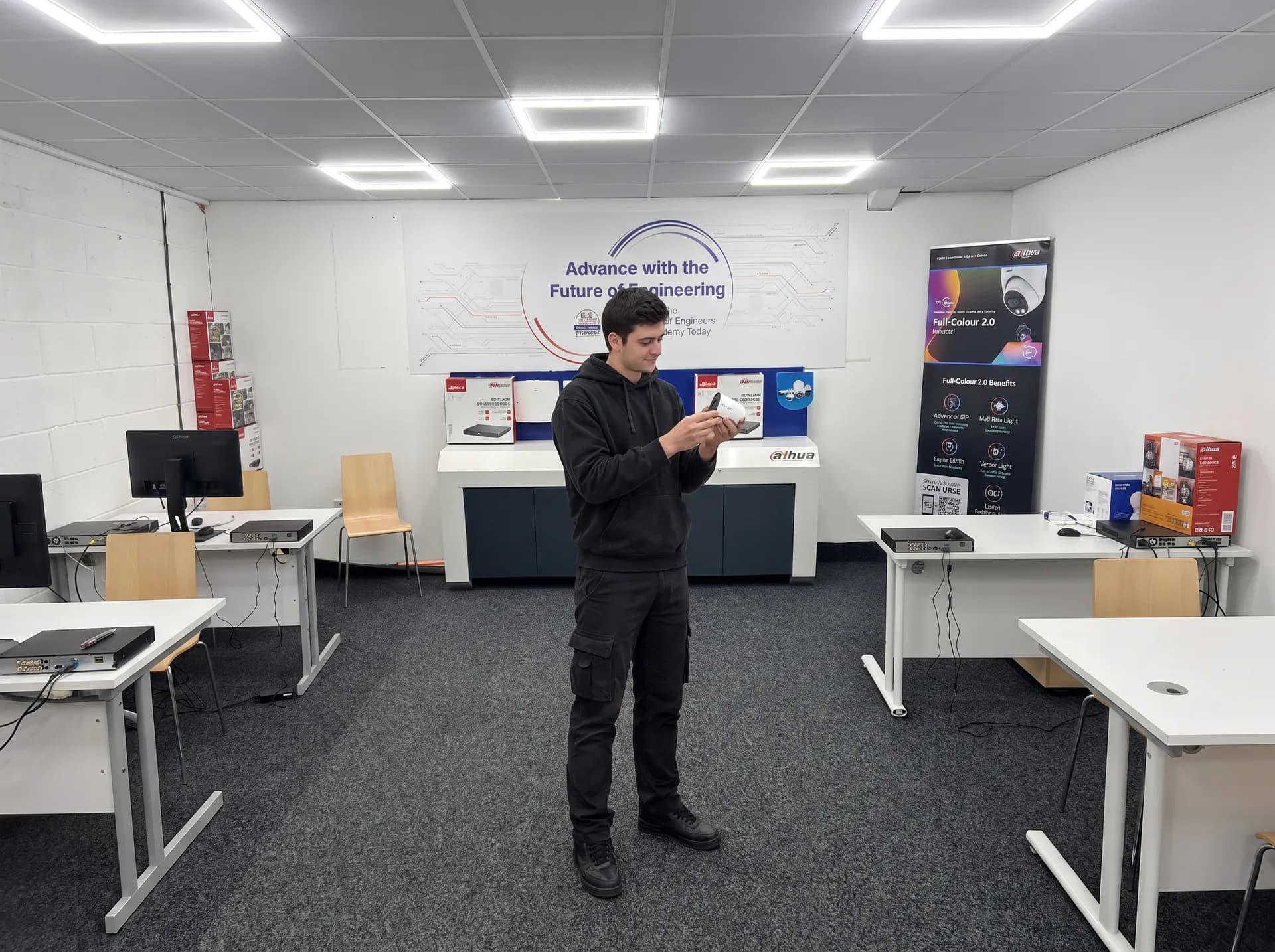Trainee holding a tablet in a training room