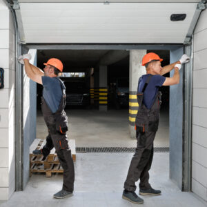 Workers are installing lifting gates of the garage.