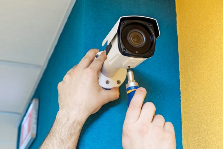 CCTV installation technician fitting security camera