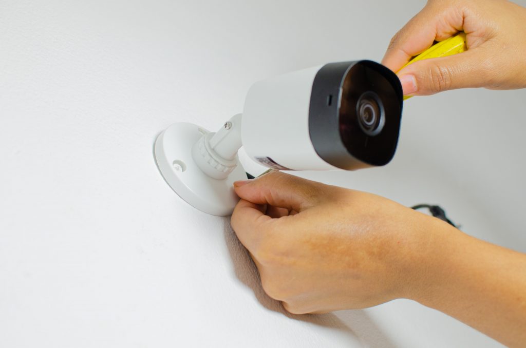 Technician installing CCTV security camera