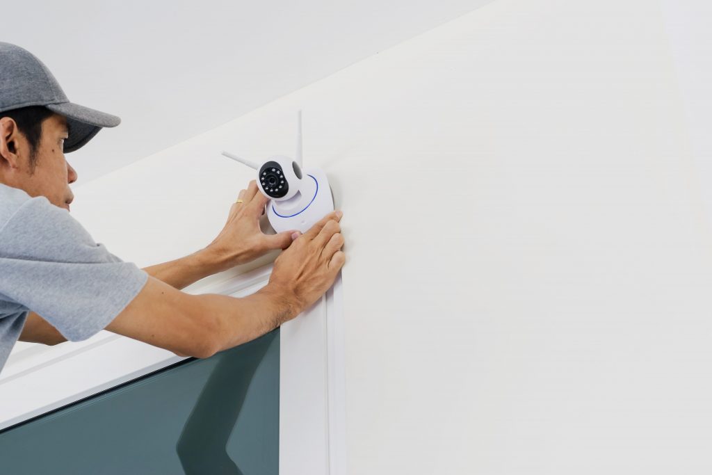 Technicians installing wireless CCTV camera